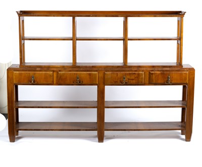 Lot 203 - A 1930s walnut dresser, the rack fitted two...