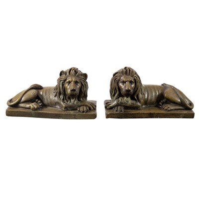 Lot 8 - A pair of painted pottery recumbent lions on...