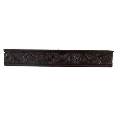 Lot 16 - A carved oak panel with scrolls, foliage, etc,...