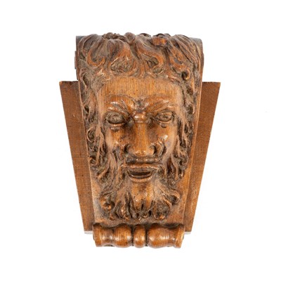 Lot 28 - A mask head carving of a bearded man on a...
