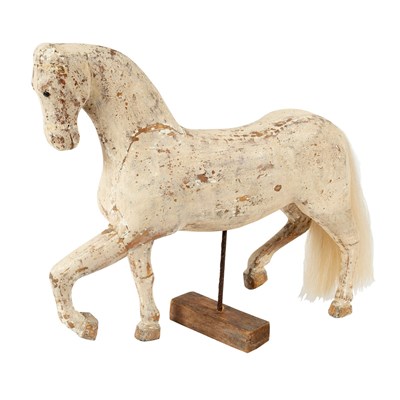 Lot 103 - A white painted carved wooden walking horse on...