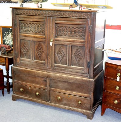 Lot 111 - An 18th Century oak press cupboard with carved...