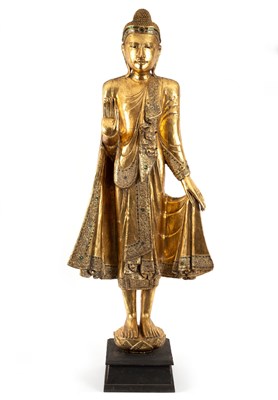 Lot 162 - A standing figure of Buddha gilded and with...