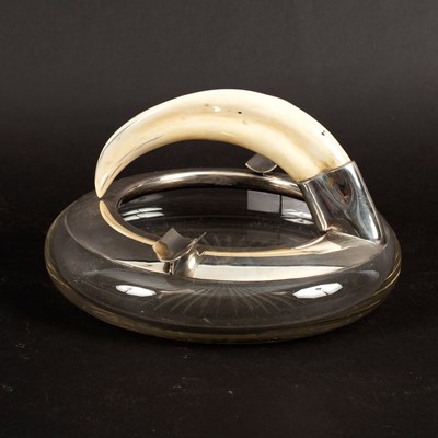 Lot 200 - A plated cigar tray with tusk handle and glass...