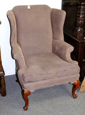 Lot 218 - A wingback armchair of 18th century style, on...