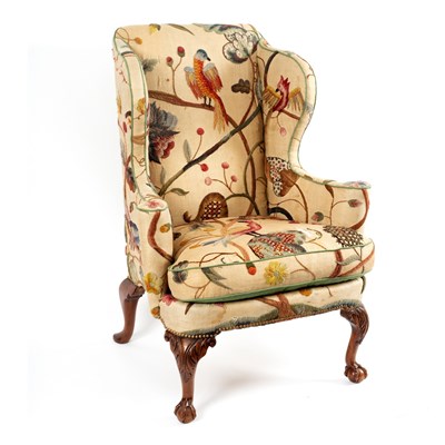 Lot 235 - A wing back armchair of George II style, on...