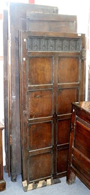 Lot 297 - An oak two-door wardrobe, with carved upper...