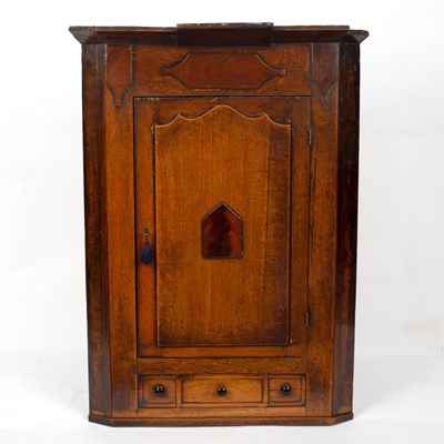 Lot 299 - A 19th Century oak corner cupboard, fitted a...