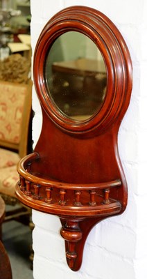 Lot 349 - A circular wall mirror with galleried shelf...