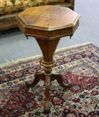 Lot 351 - A Victorian walnut work table on a carved...