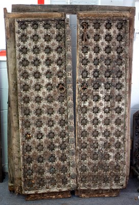 Lot 370 - A pair of carved and brass studded doors with...