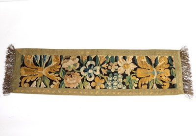 Lot 383 - An 18th Century tapestry fragment, bound as a...