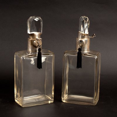 Lot 646 - A pair of silver mounted lockable decanters,...