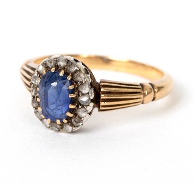 Lot 695 - A sapphire and diamond cluster ring, the oval...