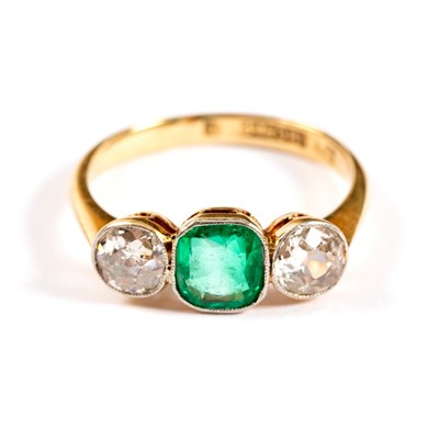 Lot 706 - An emerald and diamond three-stone ring, the...