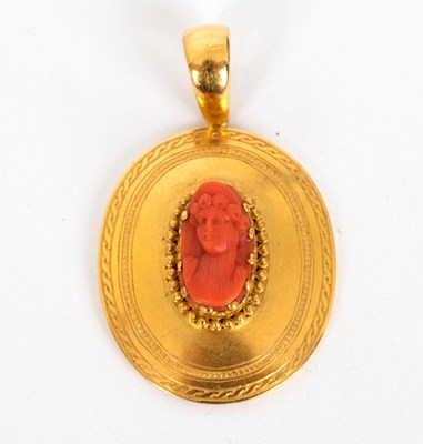 Lot 718 - A coral cameo pendant, the carved coral...