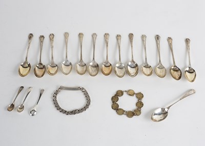 Lot 31 - Thirteen silver teaspoons, a silver identity...