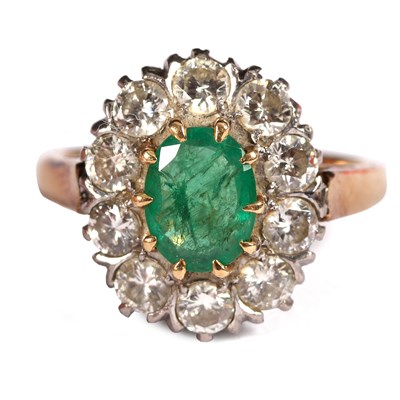 Lot 102 - An emerald and diamond cluster ring, the oval...