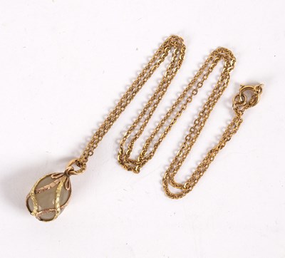 Lot 121 - A Russian gold and hardstone egg form pendant,...