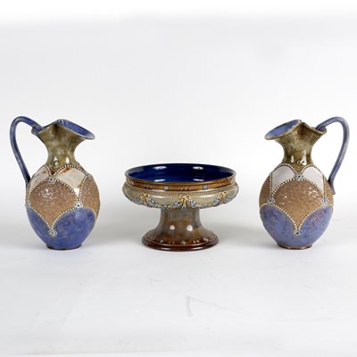 Lot 166 - A pair of Royal Doulton stoneware ewers, with...