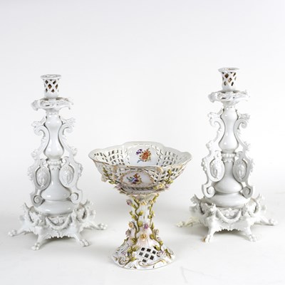 Lot 216 - A pair of German porcelain candlesticks, the...