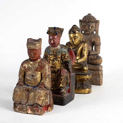 Lot 249 - A carved wooden figure of a Buddha with gilded...