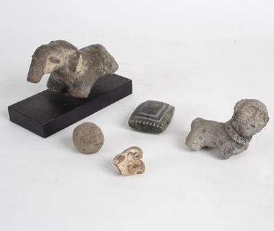 Lot 258 - A carved stone fragment of an elephant on a...