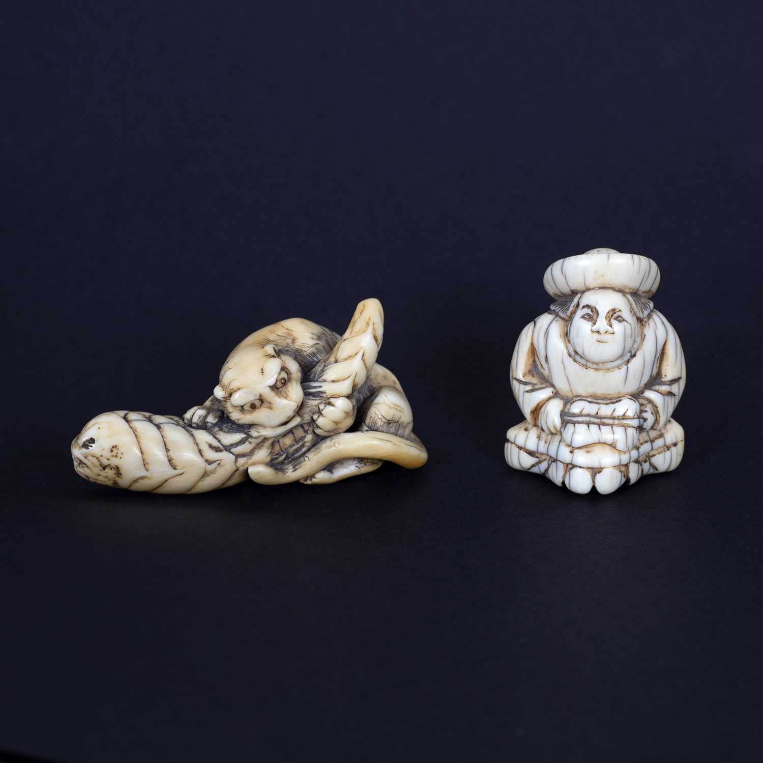 Lot 275 - A Japanese carved ivory netsuke of a tiger...