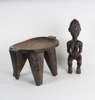 Lot 310 - A tribal stool with concave seat on tapering...