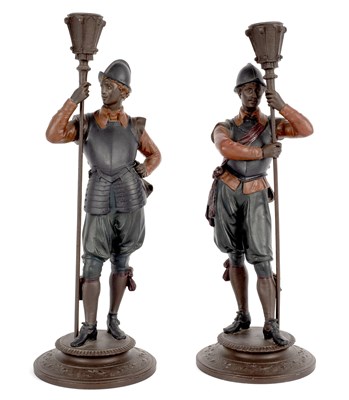 Lot 330 - A pair of figural candlesticks, the supports...