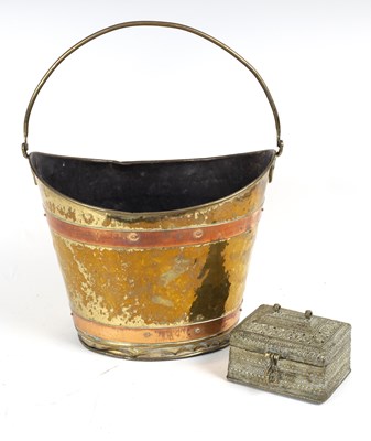 Lot 342 - An oval brass bucket with copper bands and...