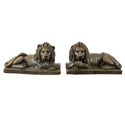 Lot 383 - A pair of painted pottery recumbent lions on...