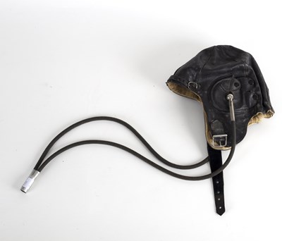 Lot 416 - A leather flying helmet, labels inside for TC...