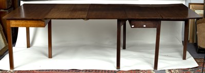 Lot 636 - A George III mahogany two-flap dining table,...