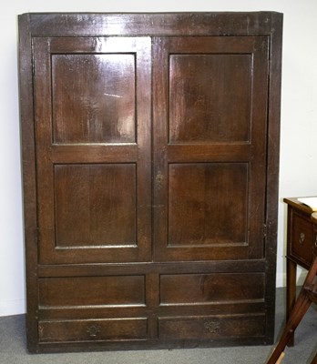 Lot 639 - An 18th Century oak wardrobe, enclosed by a...