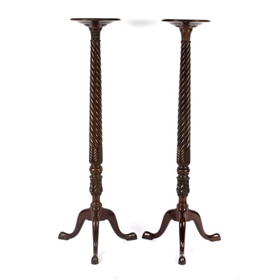 Lot 691 - A pair of George III style mahogany tripod...