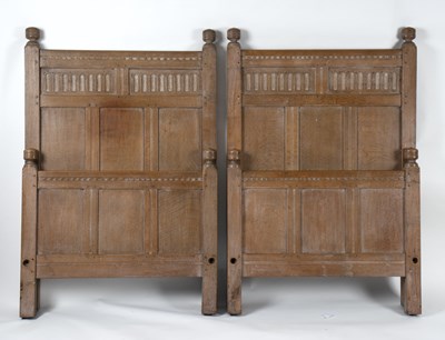 Lot 713 - A pair of Heal & Son oak single beds, with...