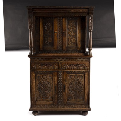 Lot 782 - A carved oak cabinet, the upper and lower...