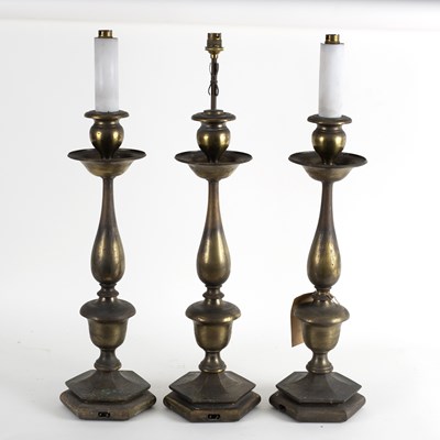 Lot 825 - Three silvered metal lamps, circa 1910, with...