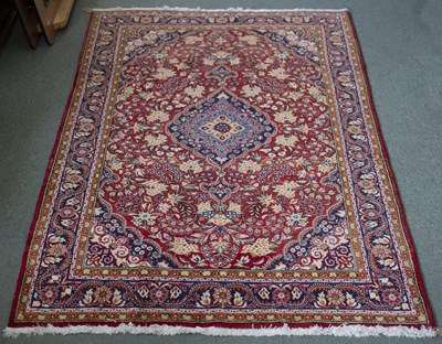 Lot 862 - A Kashan rug, the central medallion to a red...