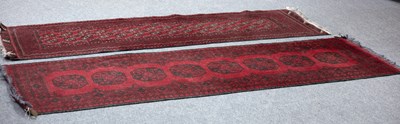 Lot 905 - Two modern Afghan rugs on a red ground, the...