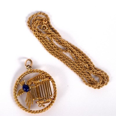 Lot 1 - An 18ct gold and gem set pendant modelled as a...