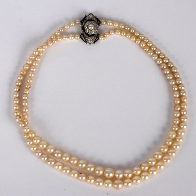 Lot 4 - A two-row pearl necklace, the rows of...