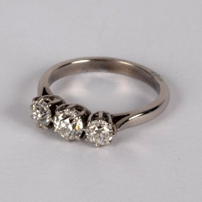 Lot 9 - A diamond three-stone ring, claw set in...