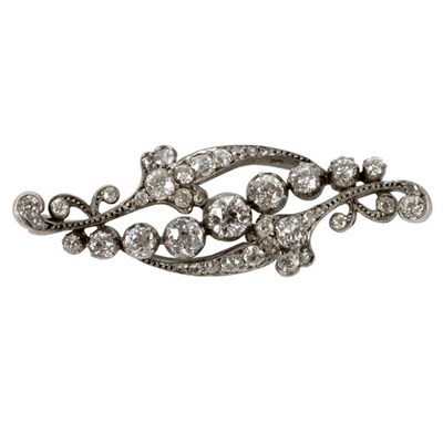 Lot 12 - A diamond brooch of scrolling form, the...