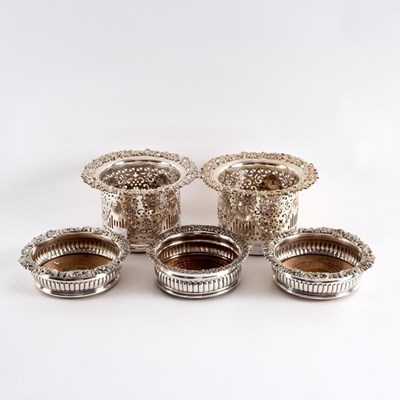Lot 80 - A pair of silver plated bottle coasters, the...