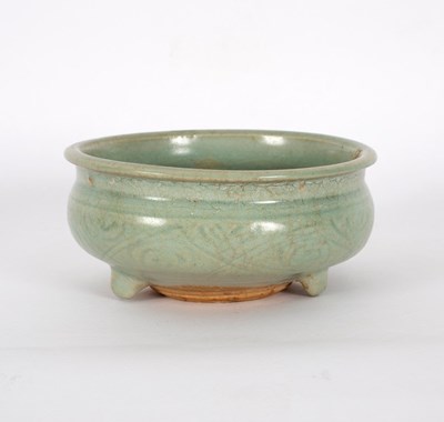 Lot 279 - A Ming celadon glaze censer, incised, on three...