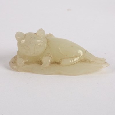 Lot 299 - A Chinese white jade figure of a cat with a...