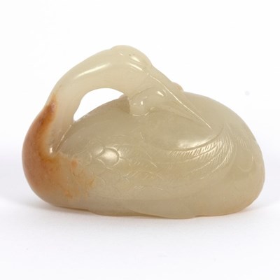 Lot 301 - A Chinese pale celadon jade and russet crane,...