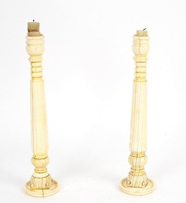 Lot 400 - A pair of Anglo-Indian ivory candlesticks made...